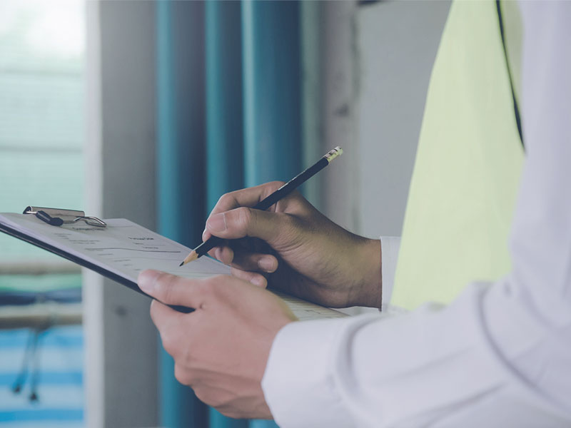 Man ticking off a rental property maintenance repair checklist