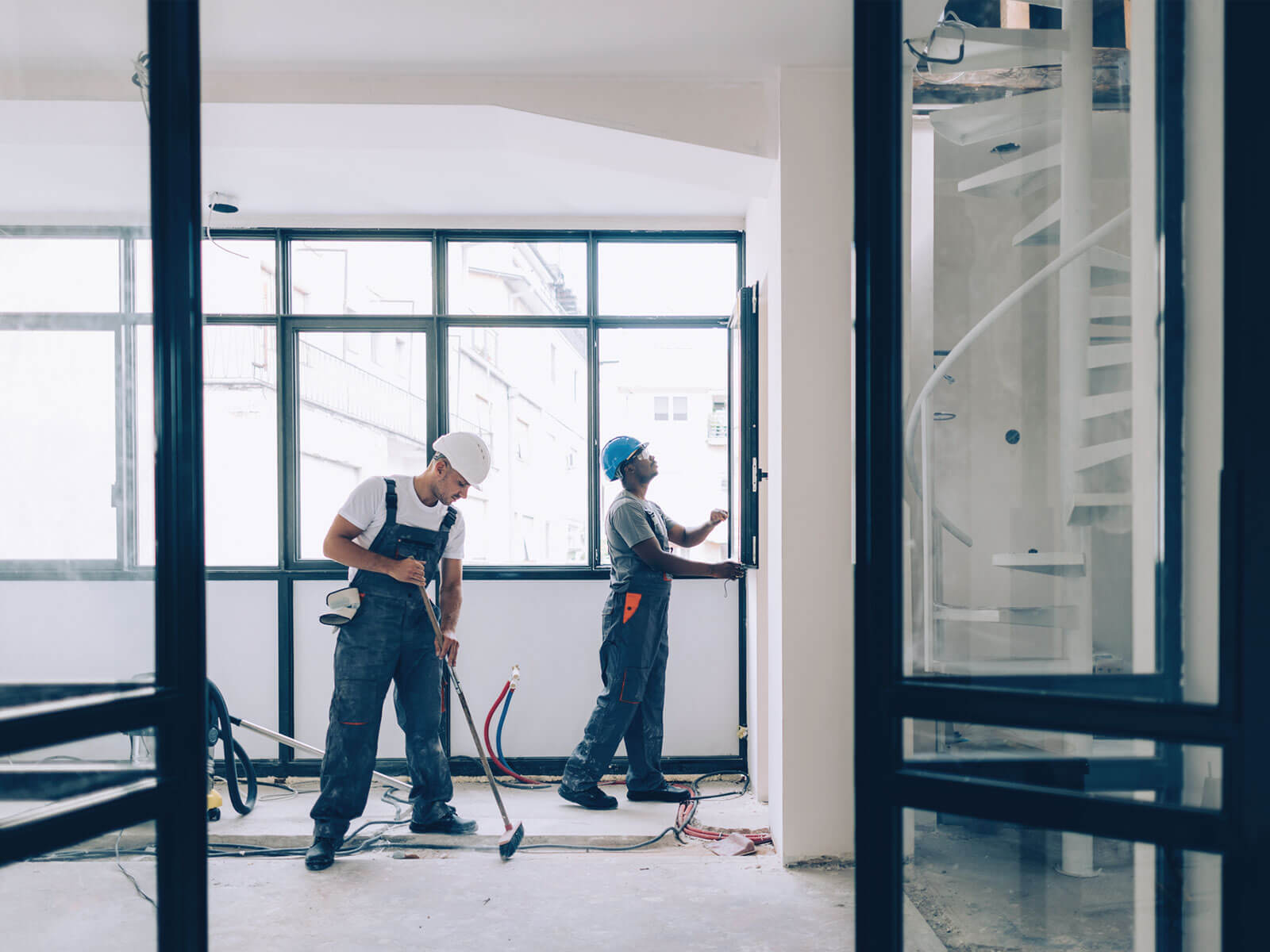 Two people refurbishing a room