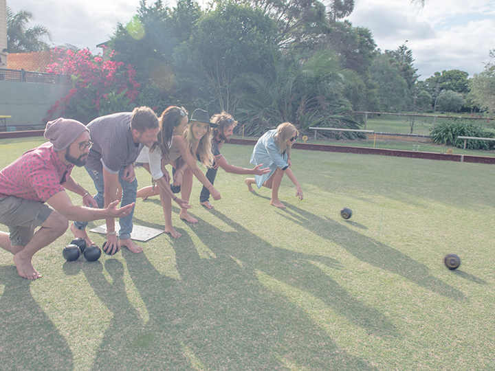 Work colleagues play lawn bowls for Christmas party. 