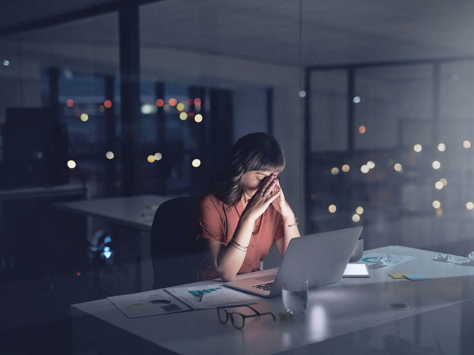 woman sitting in office at night time.