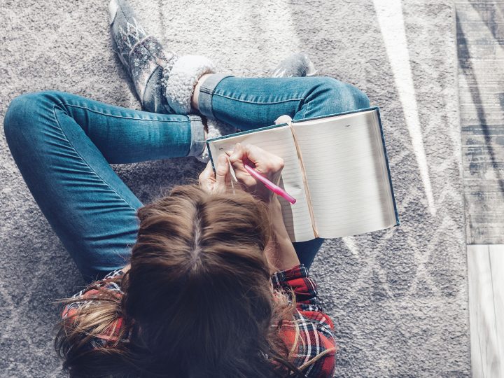 Cross legged woman sitting with journal