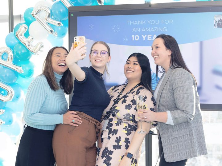 PropertyMe employees taking a selfie in front of balloons