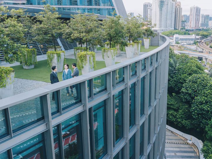 Real estate agent talking to investors on rooftop