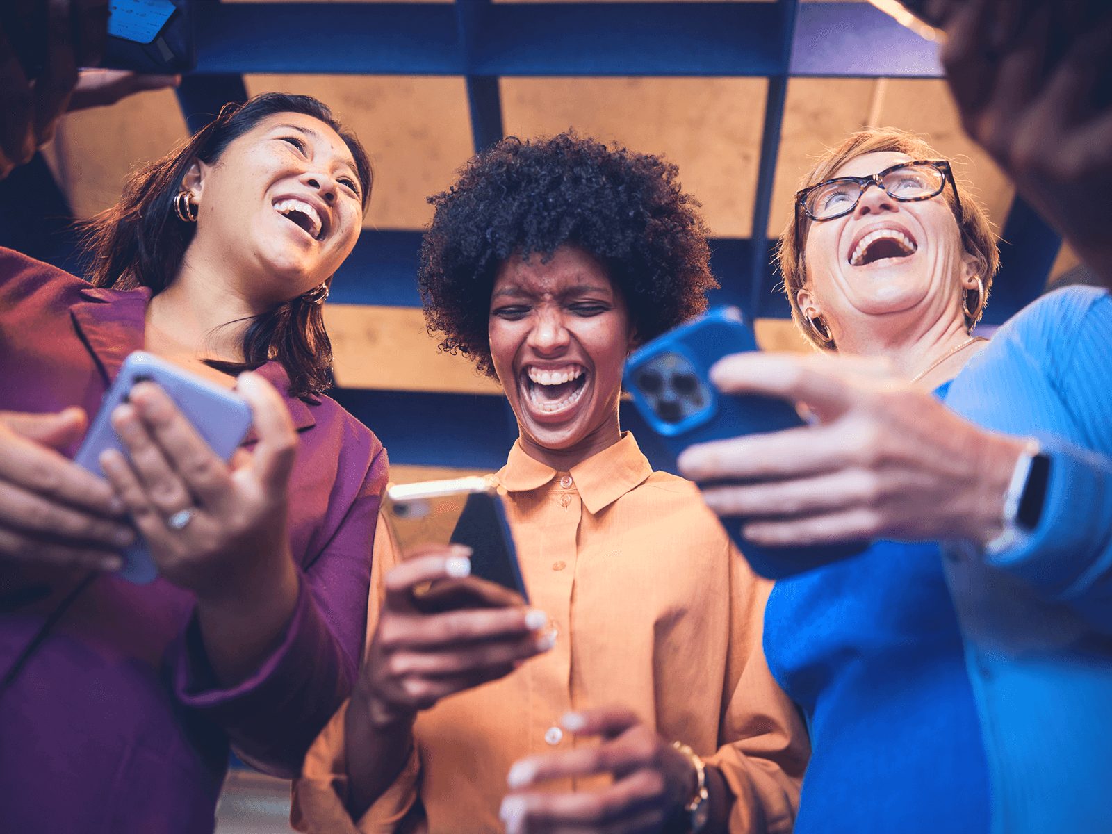 Coworkers laughing at phones